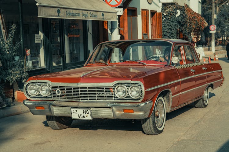 Red Classic Car Parked Beside Store