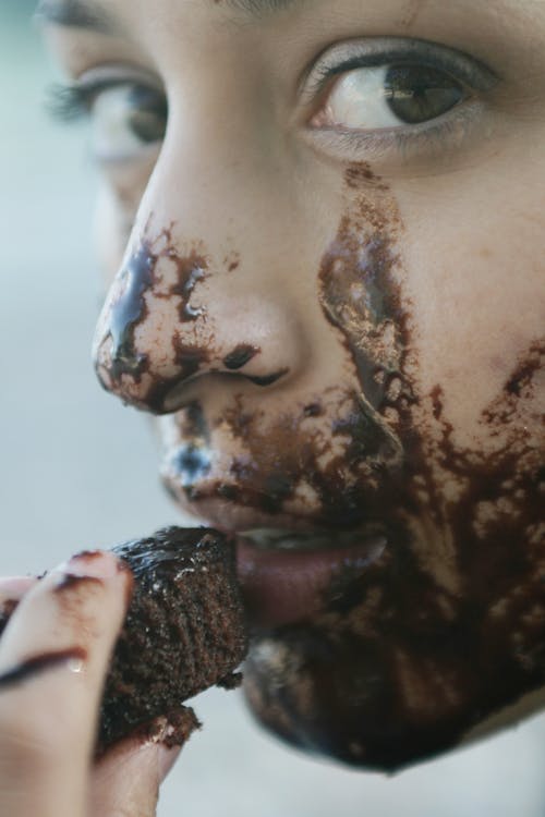 Woman Eating Chocolate Cupcake Close-up Photo