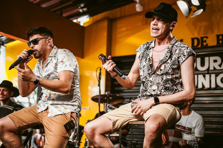 Two Men Singing On The Stage