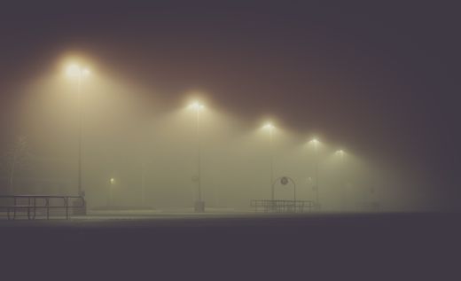 Streetlights glowing through night fog — photo by Chris F on Pexels