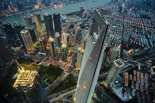 Stunning aerial view of Shanghai's illuminated skyline, featuring modern skyscrapers and vibrant cityscape at night.