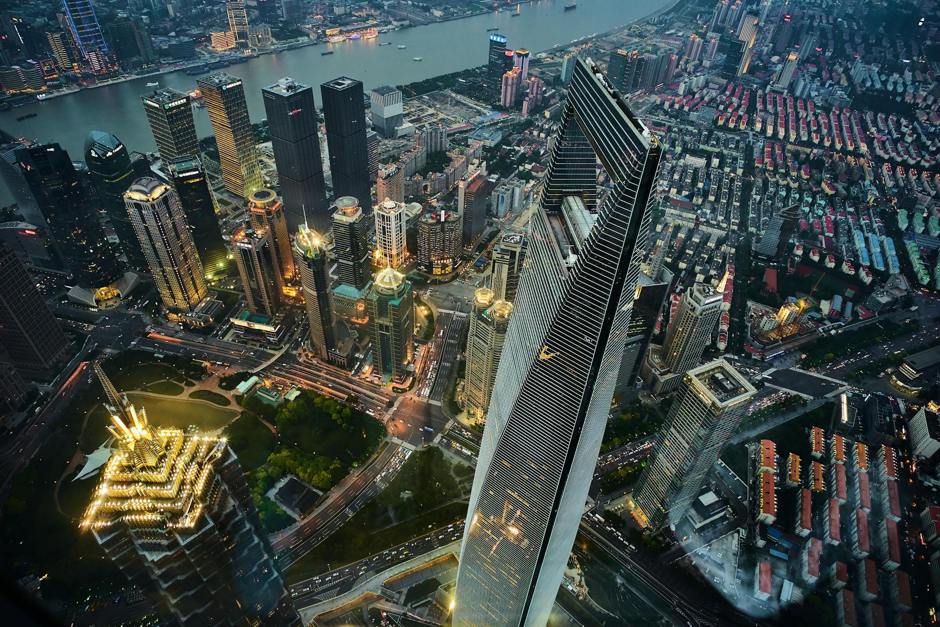 Stunning aerial view of Shanghai's illuminated skyline, featuring modern skyscrapers and vibrant cityscape at night.