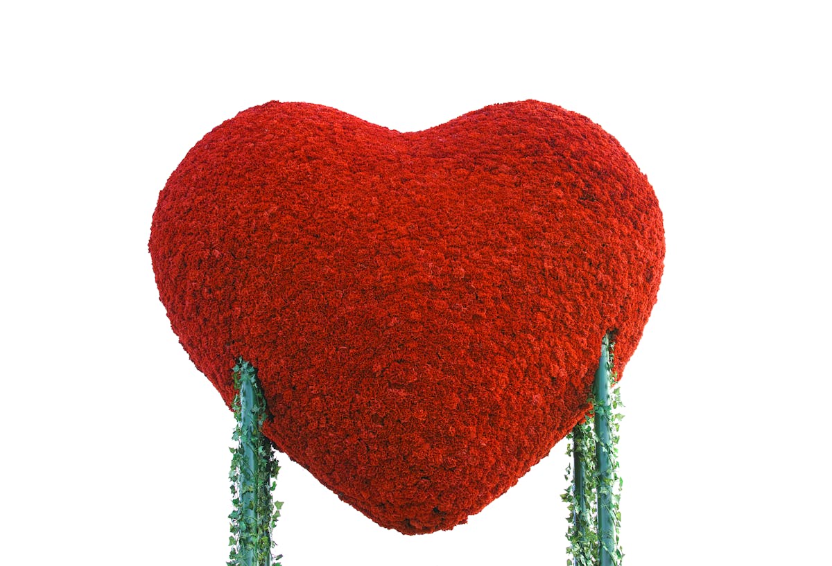 Greek yogurt bowl topped with berries, nuts, and seeds on a table