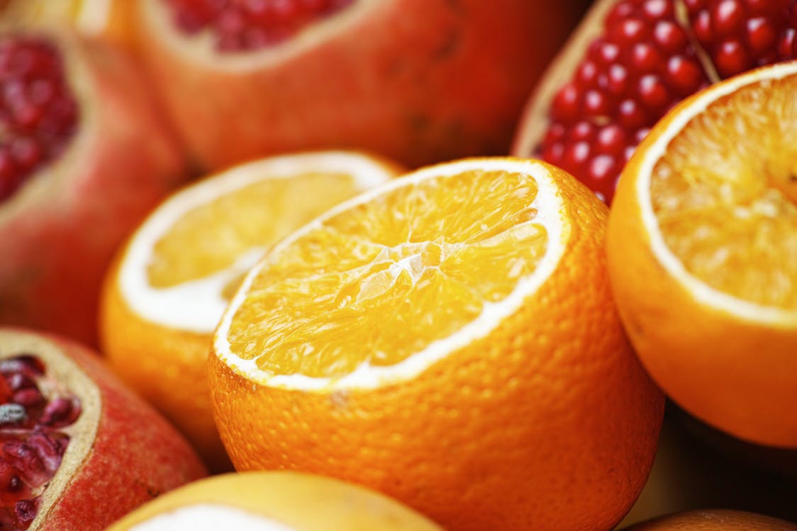 Close-up Photo of Sliced Orange and Grapefruit Fruits