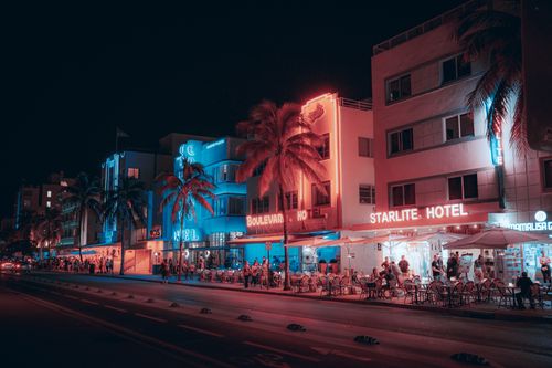 Free Colorful Art Deco hotels and lively street scene on Ocean Drive at night in Miami Beach. Stock Photo