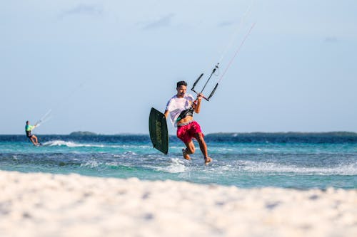 A Surfer Holding a Kiteboard