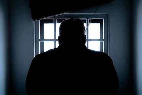 Free Rear View of a Silhouette Man in Window Stock Photo