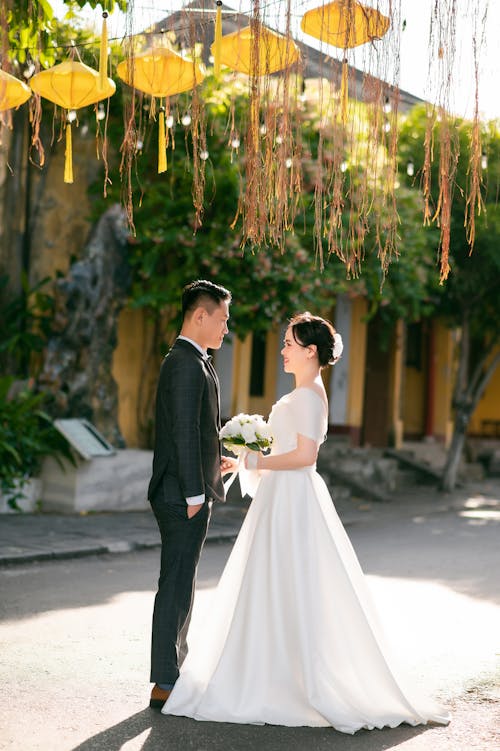 Newlyweds Standing Face to Face in the Middle of the Street