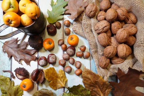 Fruits and Nuts Beside Assorted Leaves