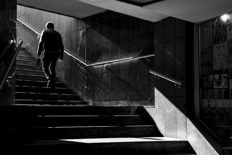 A Man Walking Up The Stairs