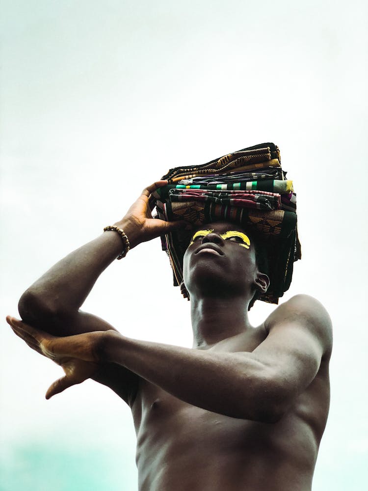 A Man Carrying Clothes On His Head