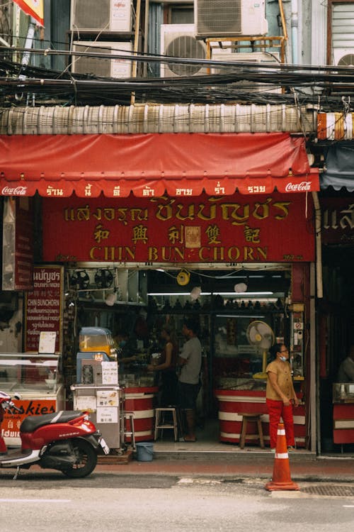 Red and White Store Front with People Inside