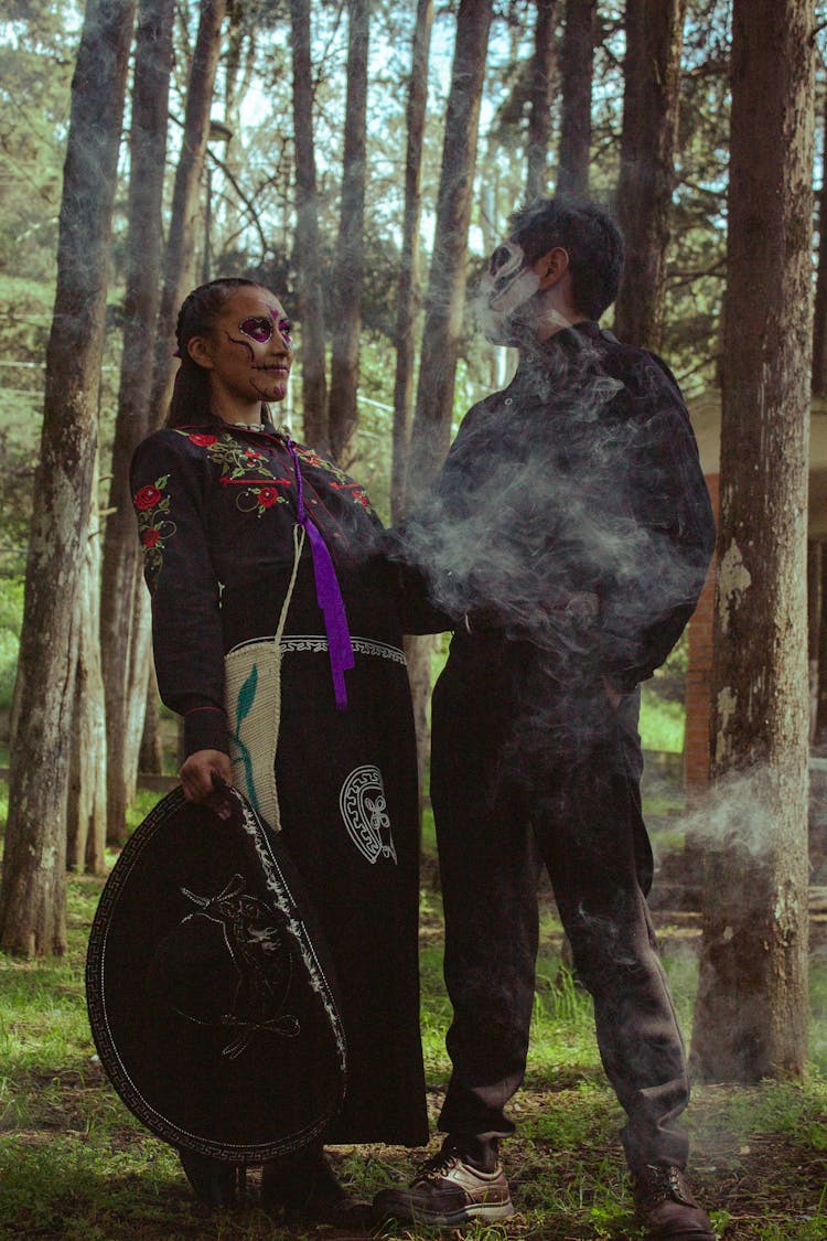 A Man And Woman Wearing Costume In The Forest