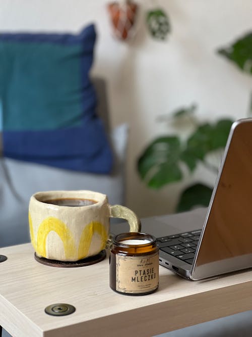 Free Coffee in Cup and Laptop on Table at Home Stock Photo