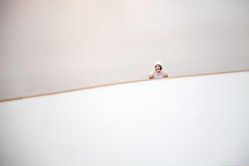 Woman Posing on Stairs in Minimalist Building