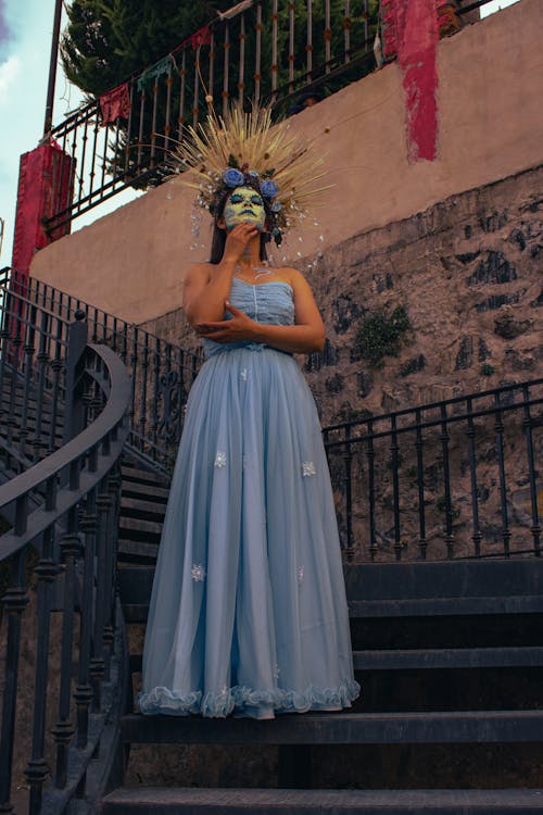 Woman in Blue Tube Dress Standing on Stairs Wearing Skull Face Makeup