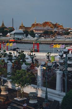 Explore a captivating view of Bangkok's famous Grand Palace overlooking the serene river.