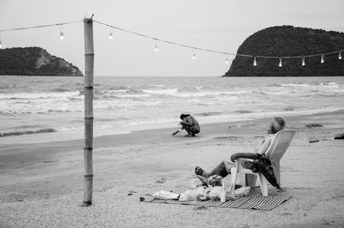 Grayscale Photo of People at the Beach