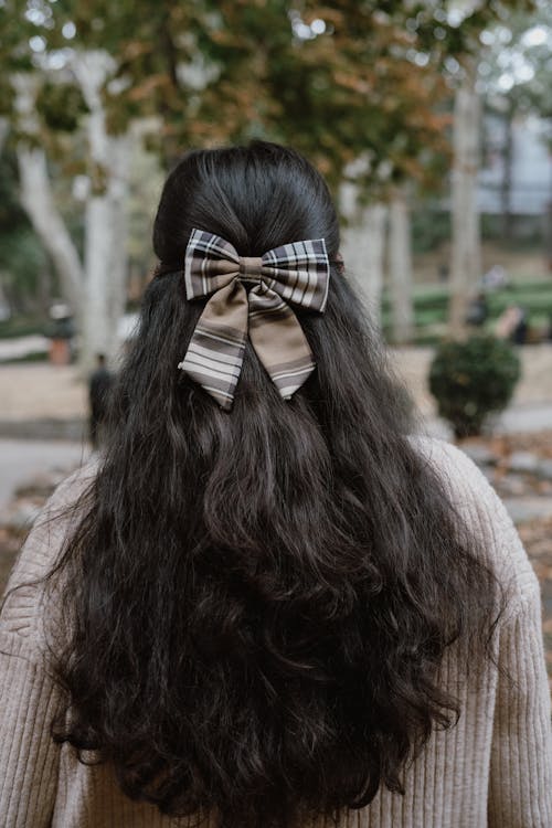 Close Up Photo of Woman Wearing Ribbon on Hair