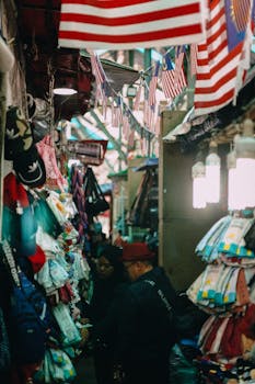 Vibrant indoor market scene with hanging flags and colorful merchandise displays.
