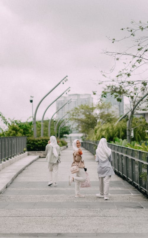 Girls in Hijabs Walking on Bridge