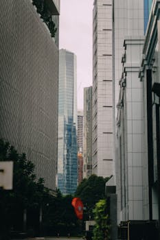A view of modern high-rise buildings surrounded by greenery in an urban setting.