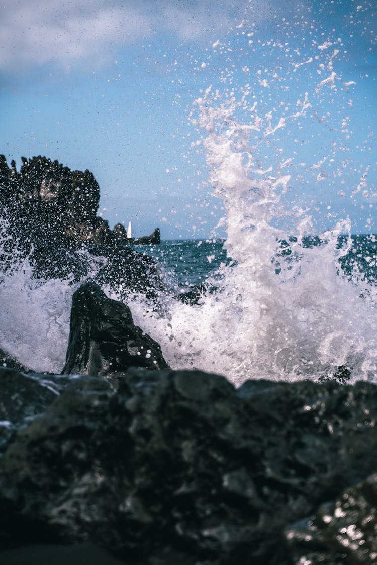 Close-Up Photo Of Water Splash Near A Rock