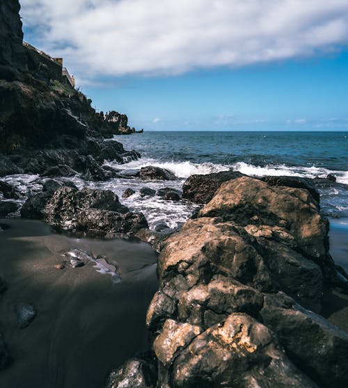 Photo of Rocks on a Shore Near the Sea