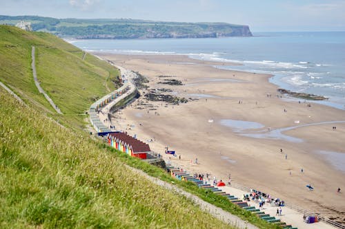 People at Sand Beach near Green Hills in Mountains