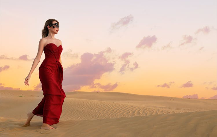 A Woman In Red Dress Walking On The Desert