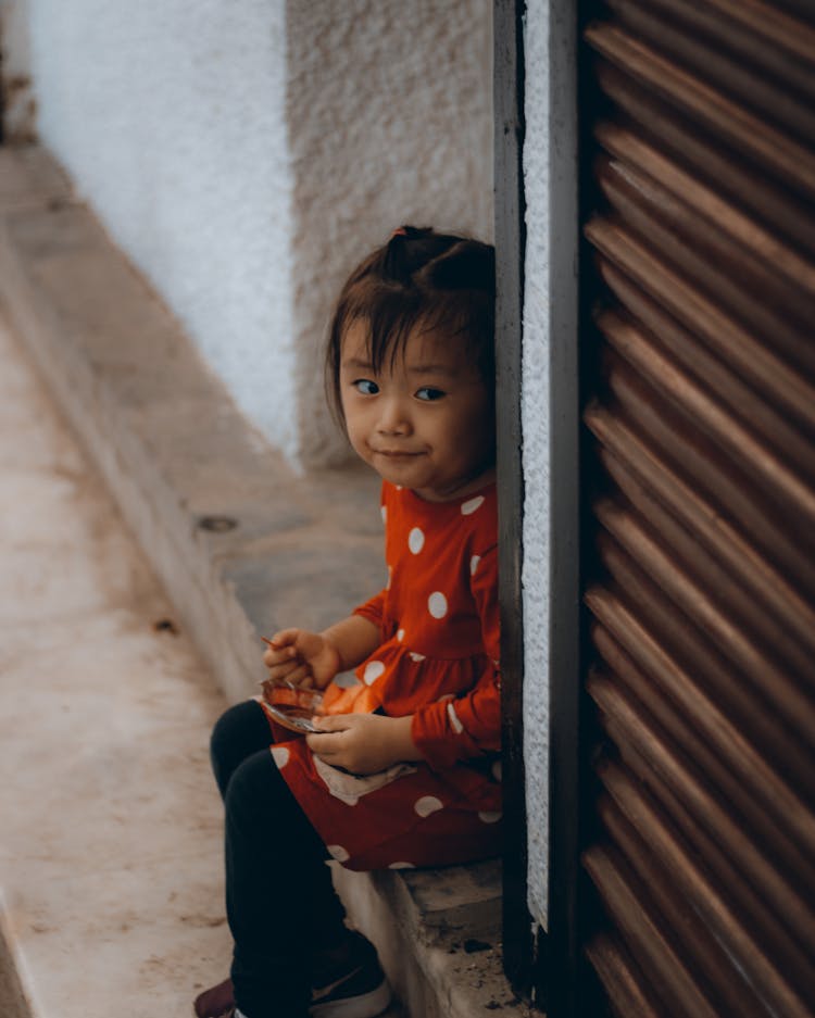 Photo Of A Child Sitting While Eating