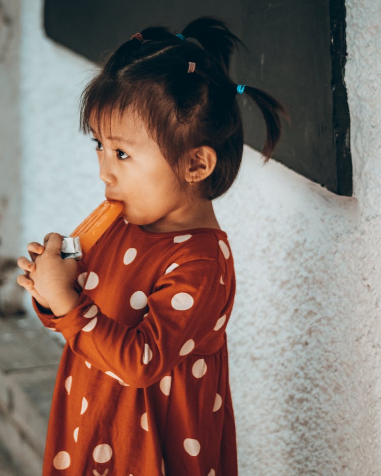 Photo Of A Child Eating A Popsicle