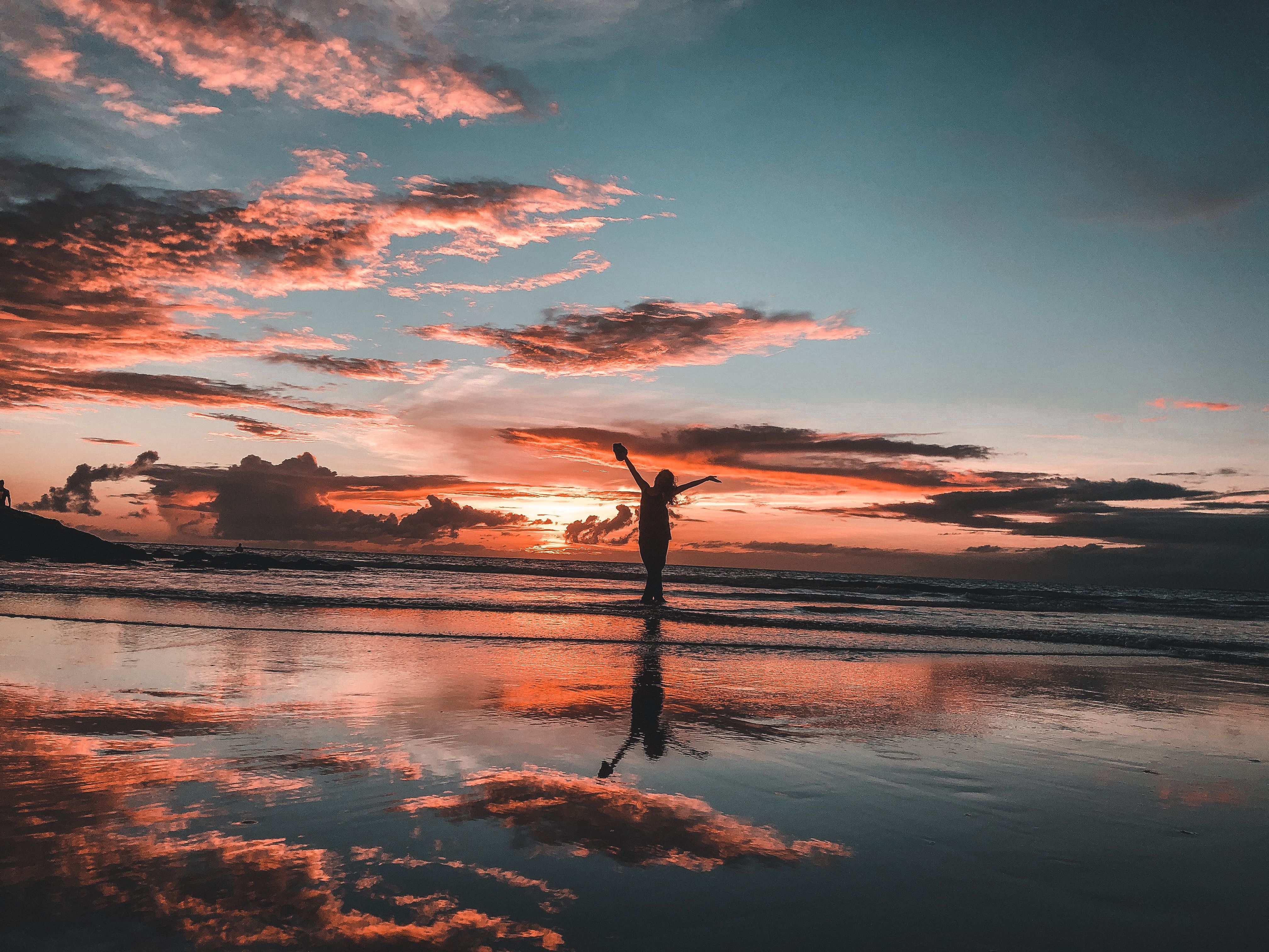 Silhouette of Woman on Beach During Sunset · Free Stock Photo