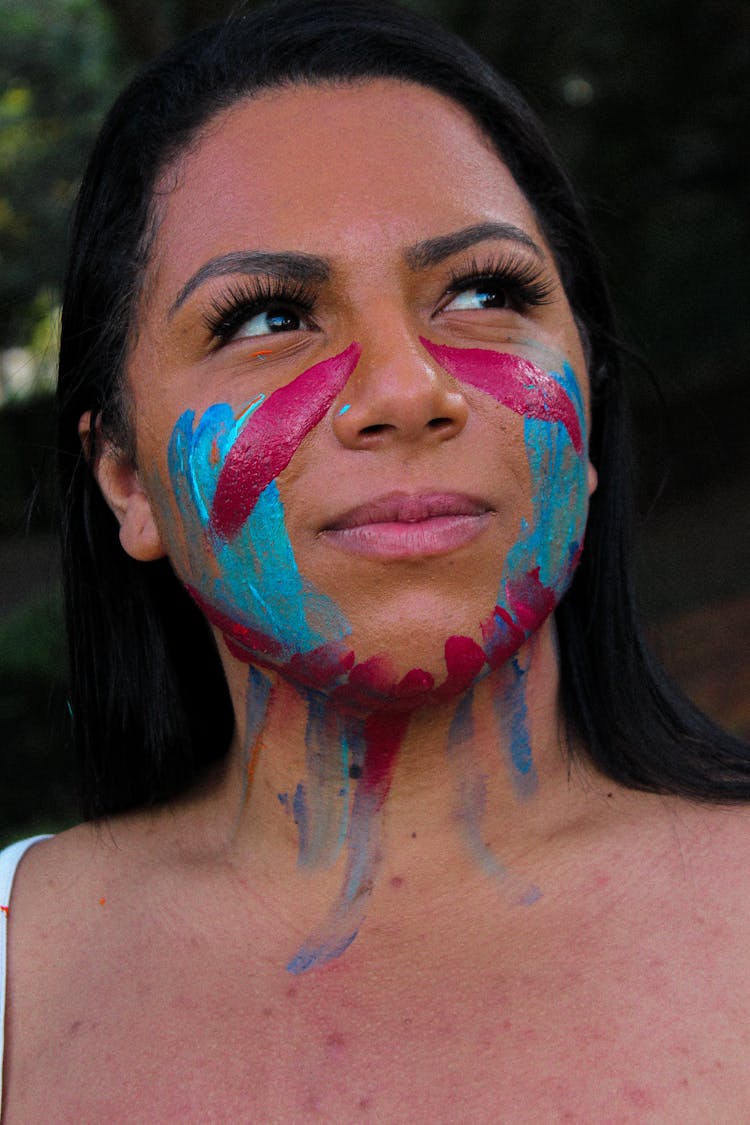 Portrait Of A Woman With Blue And Pink Face Paint