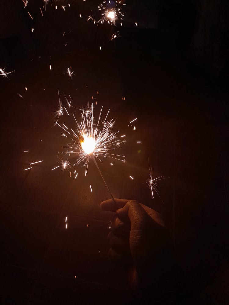 Person Holding Firecracker In Close Up Photography