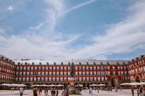 Free Scenic view of Plaza Mayor in Madrid with a vibrant blue sky and tourists. Stock Photo