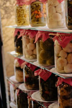 Homemade preserves under red cloth caps, photo by Busranur Aydin on Pexels