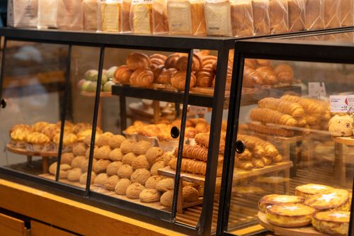 Bakery display case filled with pastries, photo by Zhengdong Hu on Pexels