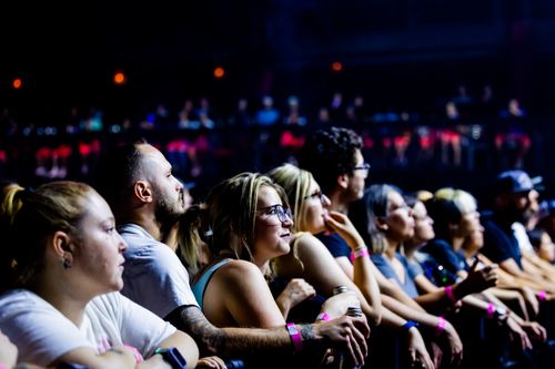 Free A lively crowd enjoys a live concert indoors, capturing the energy and excitement of the event. Stock Photo