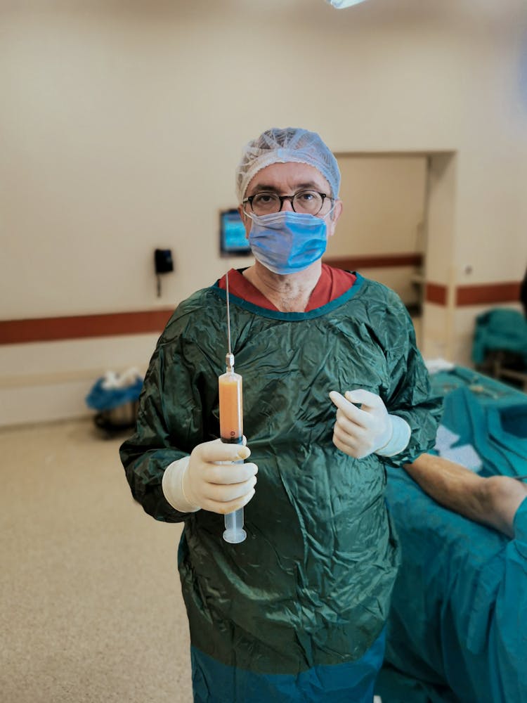 Surgeon Holding A Medical Instrument Used For Liposuction