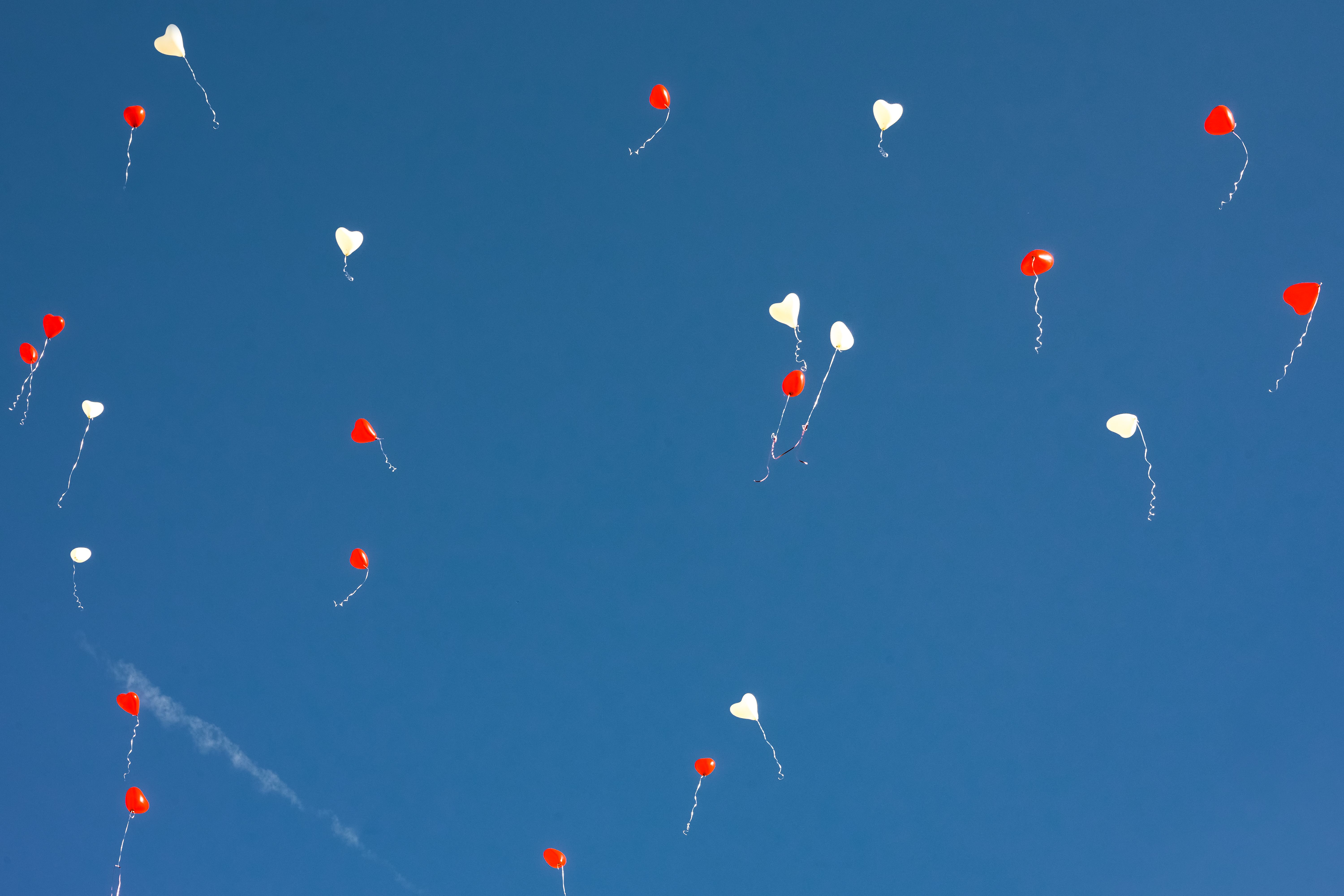 Heart-Shaped Balloons in the Blue Sky · Free Stock Photo