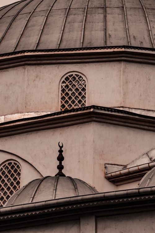 Free Detailed view of a mosque's architectural elements with crescent motifs and windows. Stock Photo