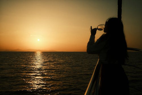 A Woman Drinking Wine in a Boat Ride