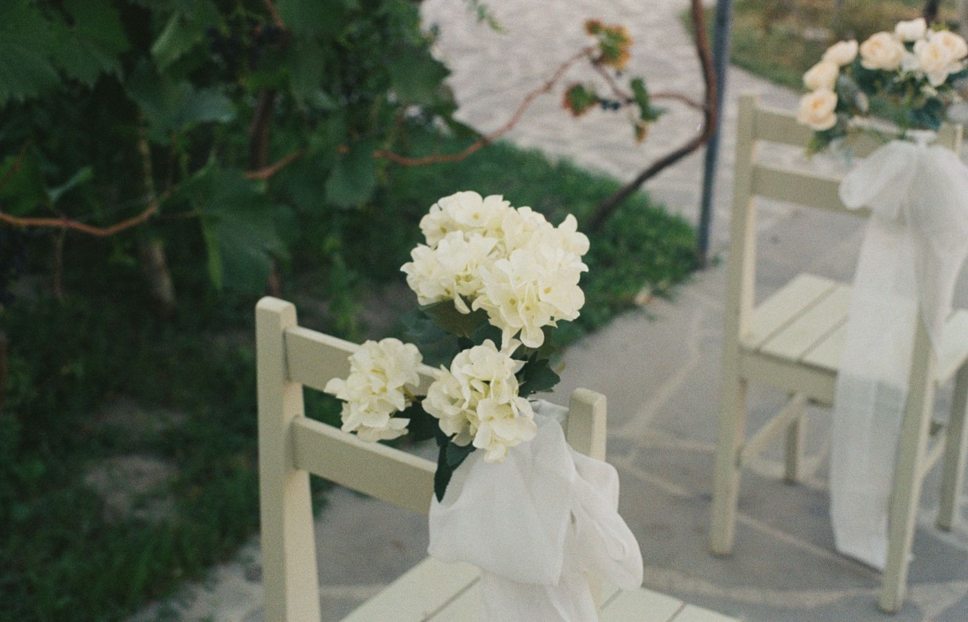 Beautifully decorated chair with white flowers at an outdoor wedding venue in Tbilisi, Georgia.