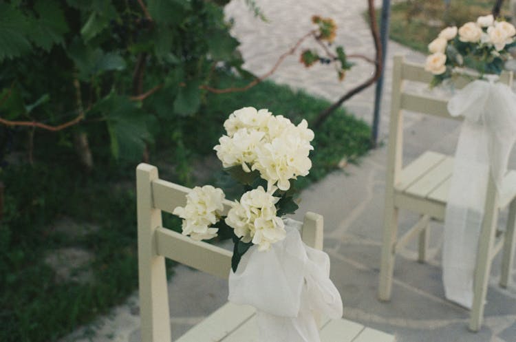 Flowers On Chairs In The Wedding Venue