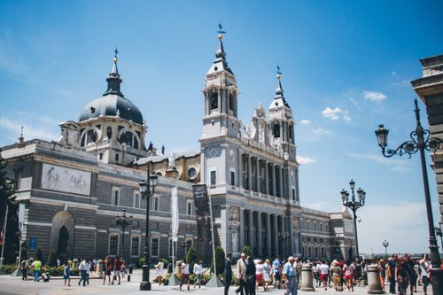 Free Almudena Cathedral in Madrid with tourists on a bright summer day. Stock Photo