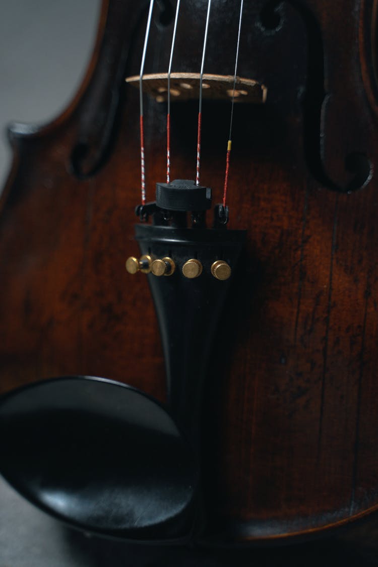 A Close-Up Shot Of The Tailpiece Of A Violin