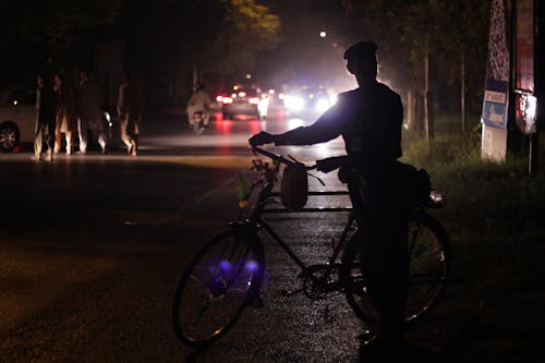 Silhouette of a man with a bicycle