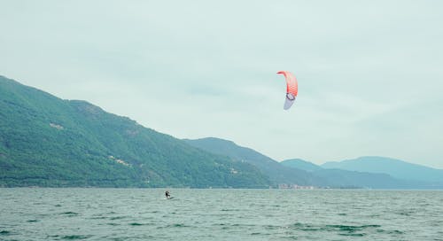 Person Kitesurfing on Lake