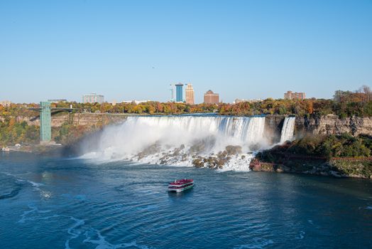 Stunning view of Niagara Falls in Ontario, Canada, with a tour boat in the foreground.